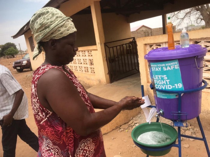 Person washing their hands at a Handwashing Station in in rural West Africa
